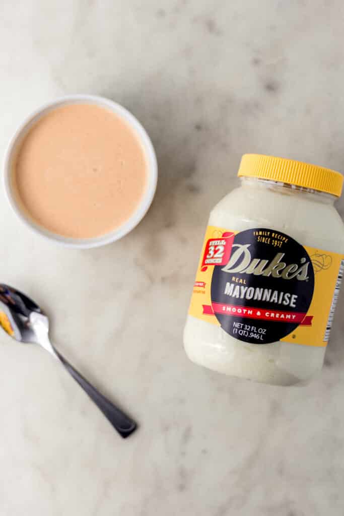 jar of Duke's Mayo next to spicy mayo mixture in white bowl and spoon