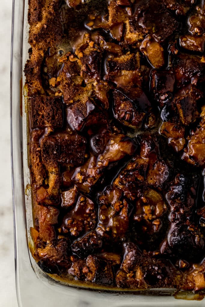 finished peach bread pudding in baking dish topped with brown sugar sauce 