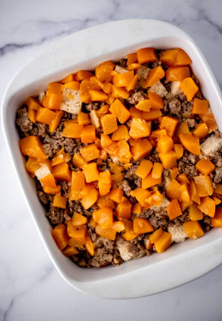ingredients for savory peach strata in square white baking dish