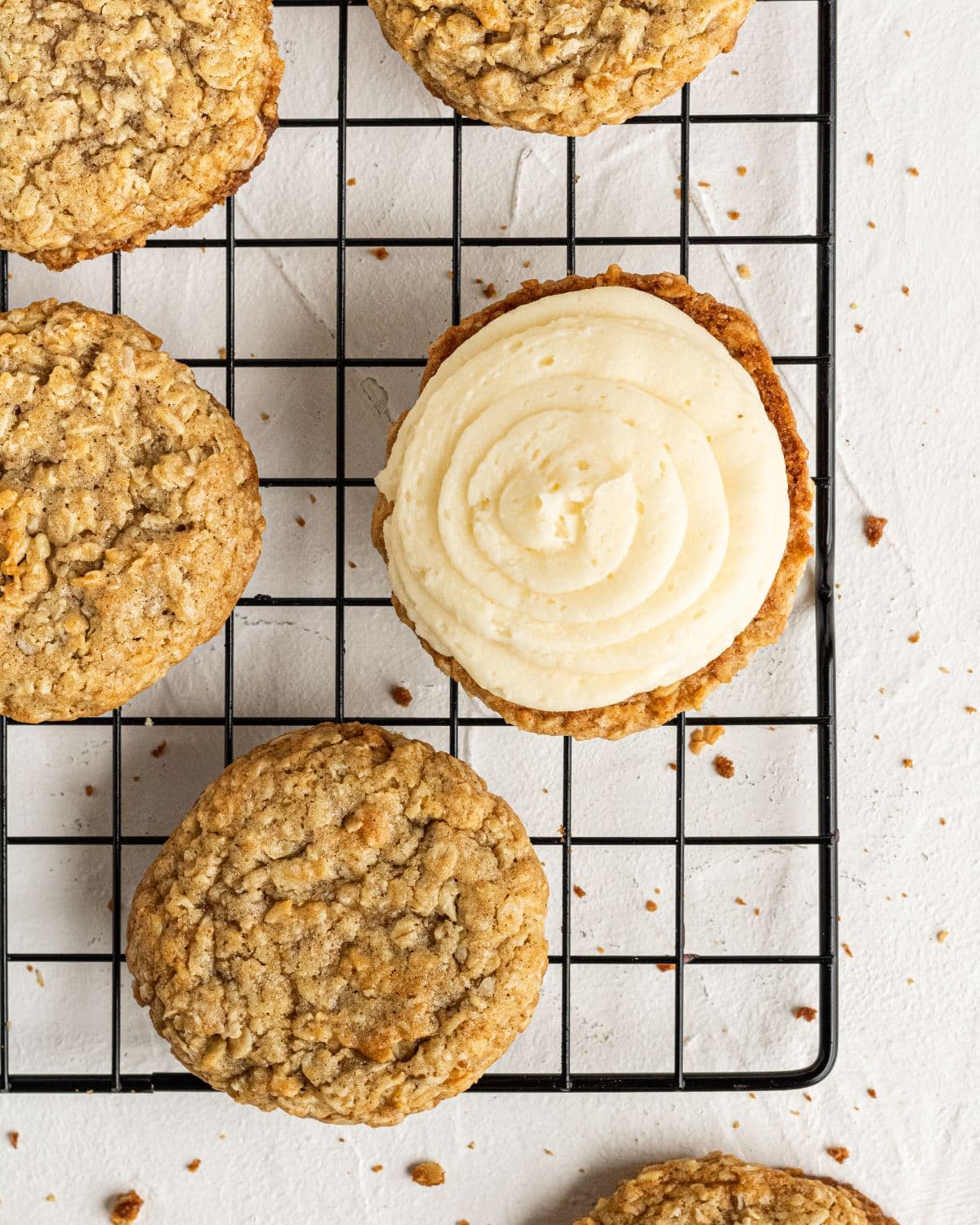 Filling added to cookies on wire rack. 
