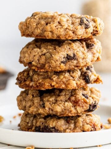 Close up side view of cookies stacked on plate.
