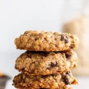 Close up side view of stacked cookies on plate on pin with text overlay.