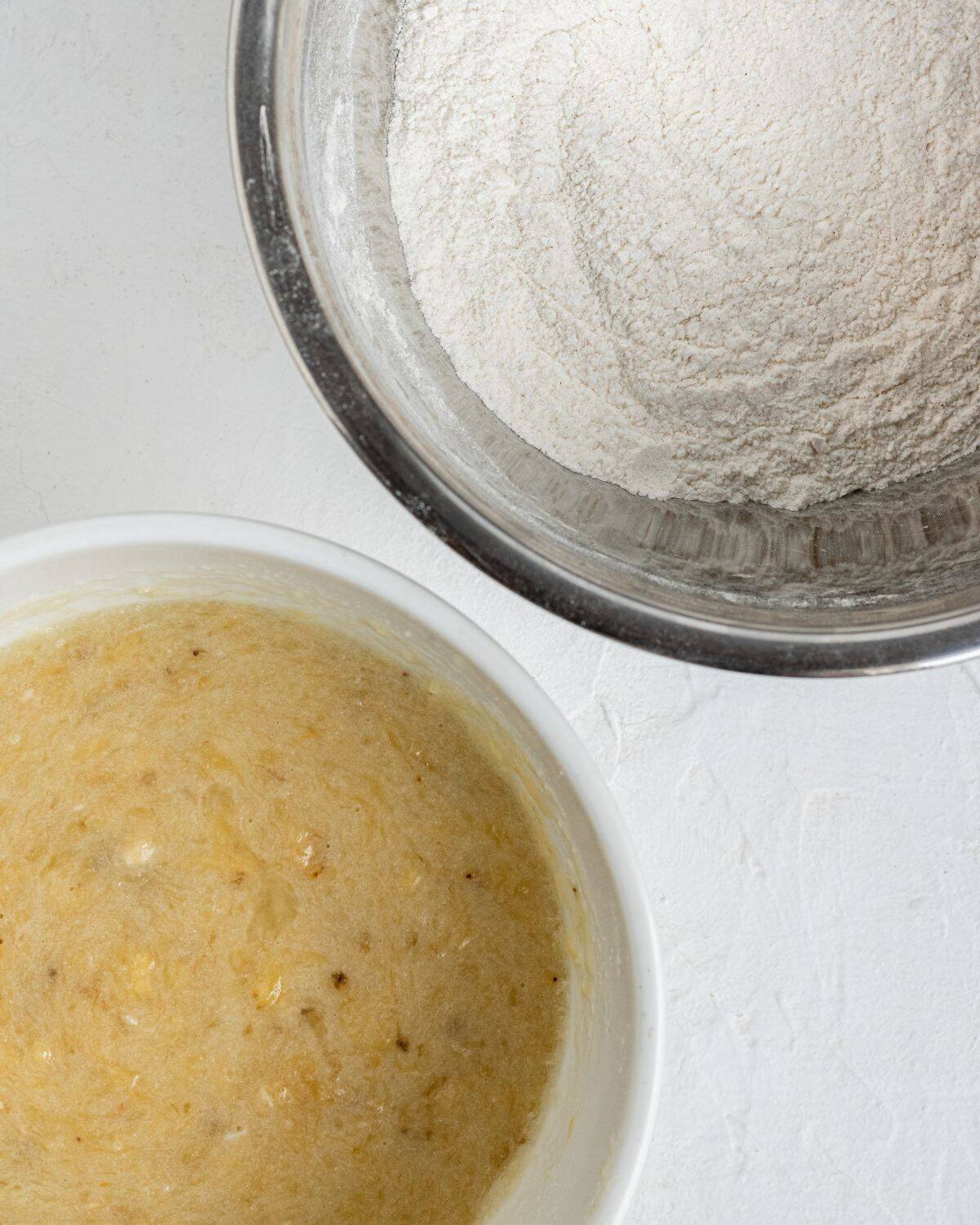 Two bowls with wet and dry ingredients. 