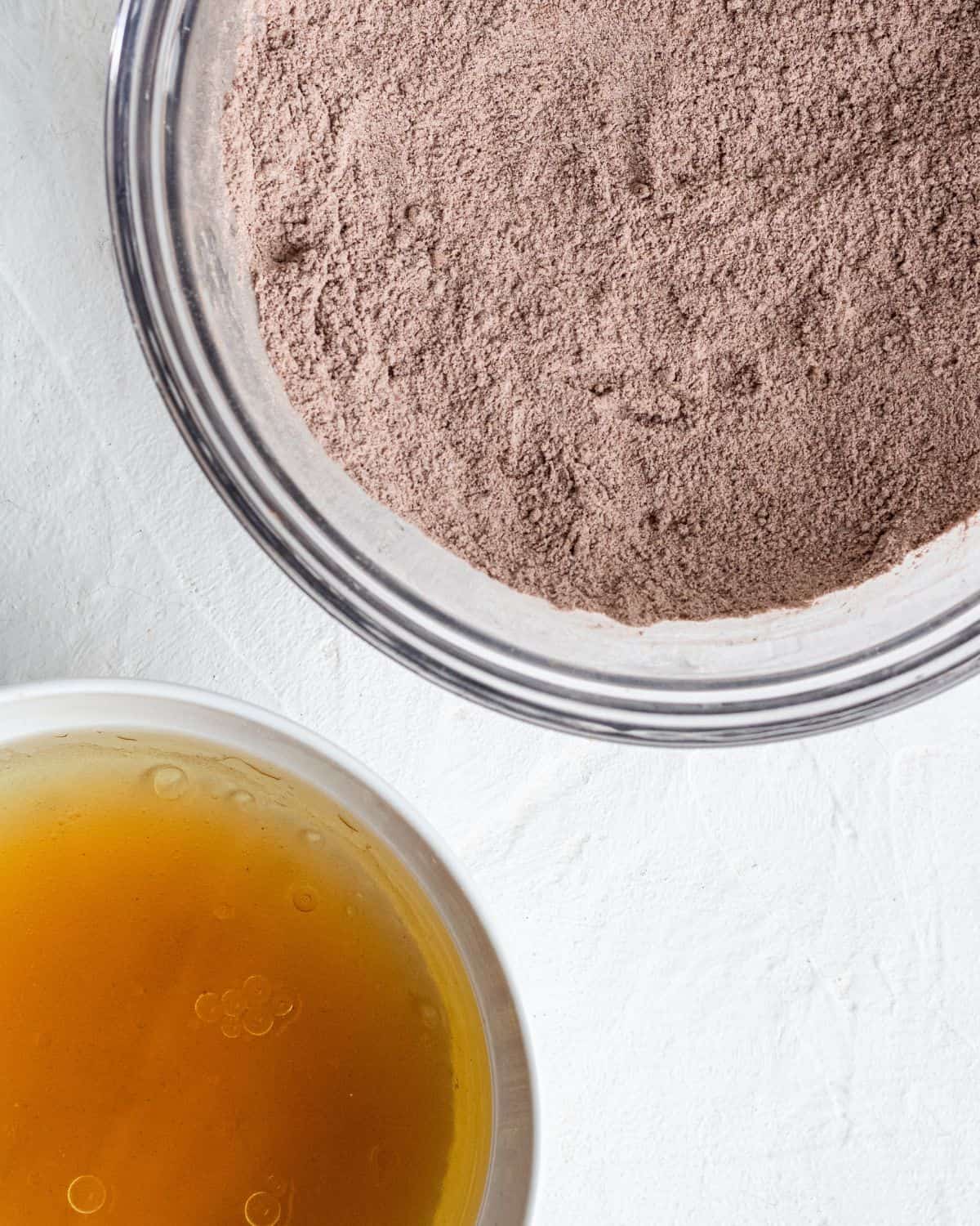 Two separate bowls with wet ingredients and dry ingredients.