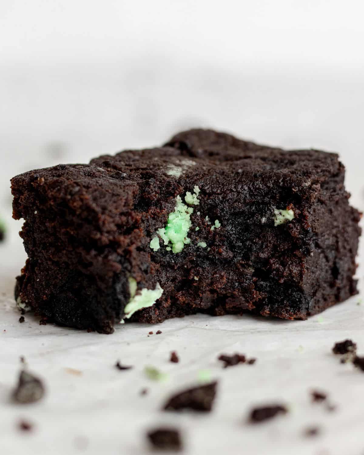 Close up view of brownie with a bite taken out of it.