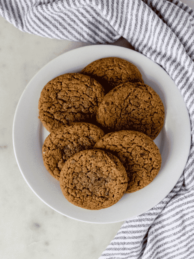 overhead view of cookies on a large white plate by cloth napkin