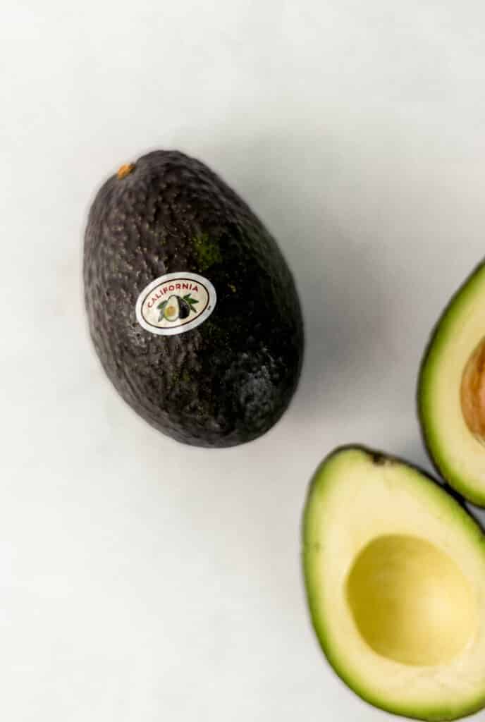 overhead view of fresh avocado with California sticker on it., 