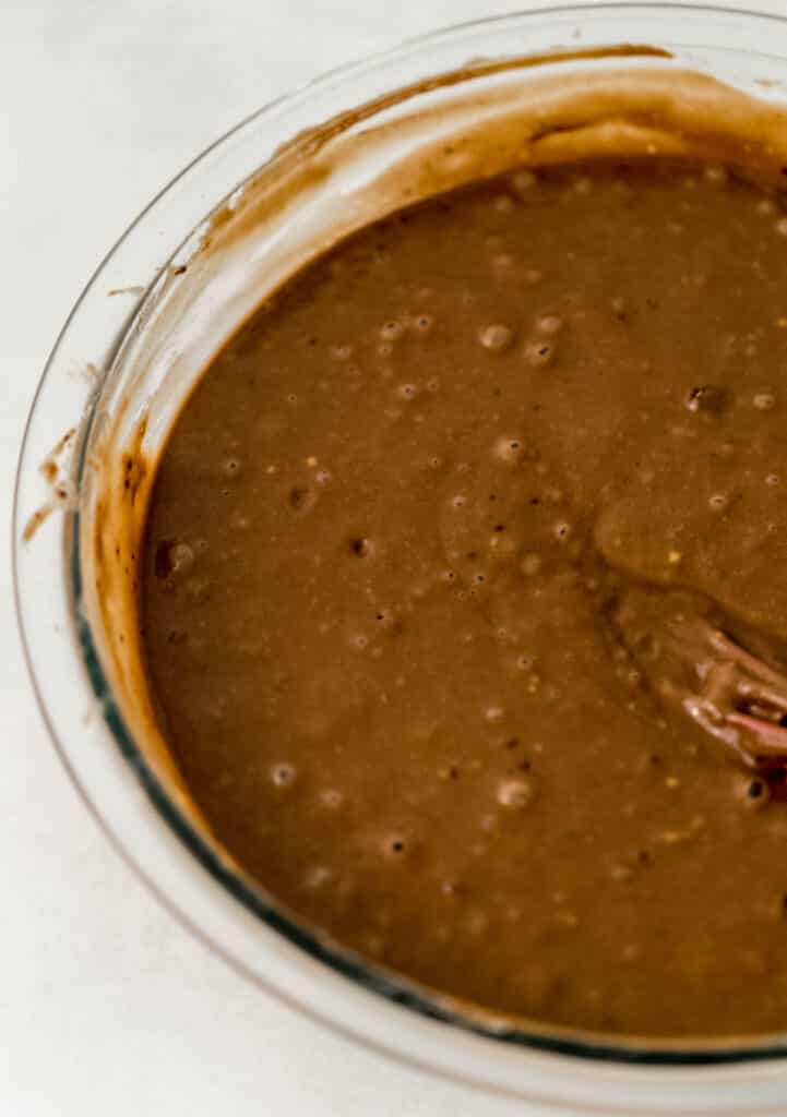 chocolate cake mixture in glass mixing bowl. 