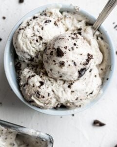 Overhead view of finished ice cream in blue bowl with spoon in it.