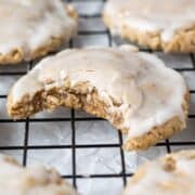 Close up view of cookie on rack with bite taken out of it.
