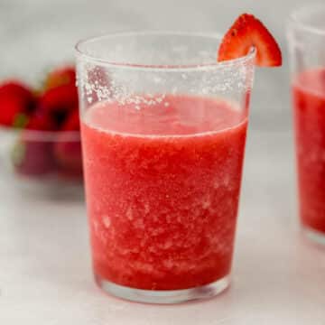 close up side view of glass of strawberry margarita