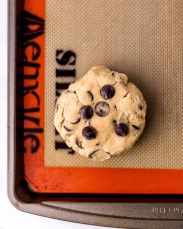 Overhead view of cookie dough before baking on silpat lined baking sheet.