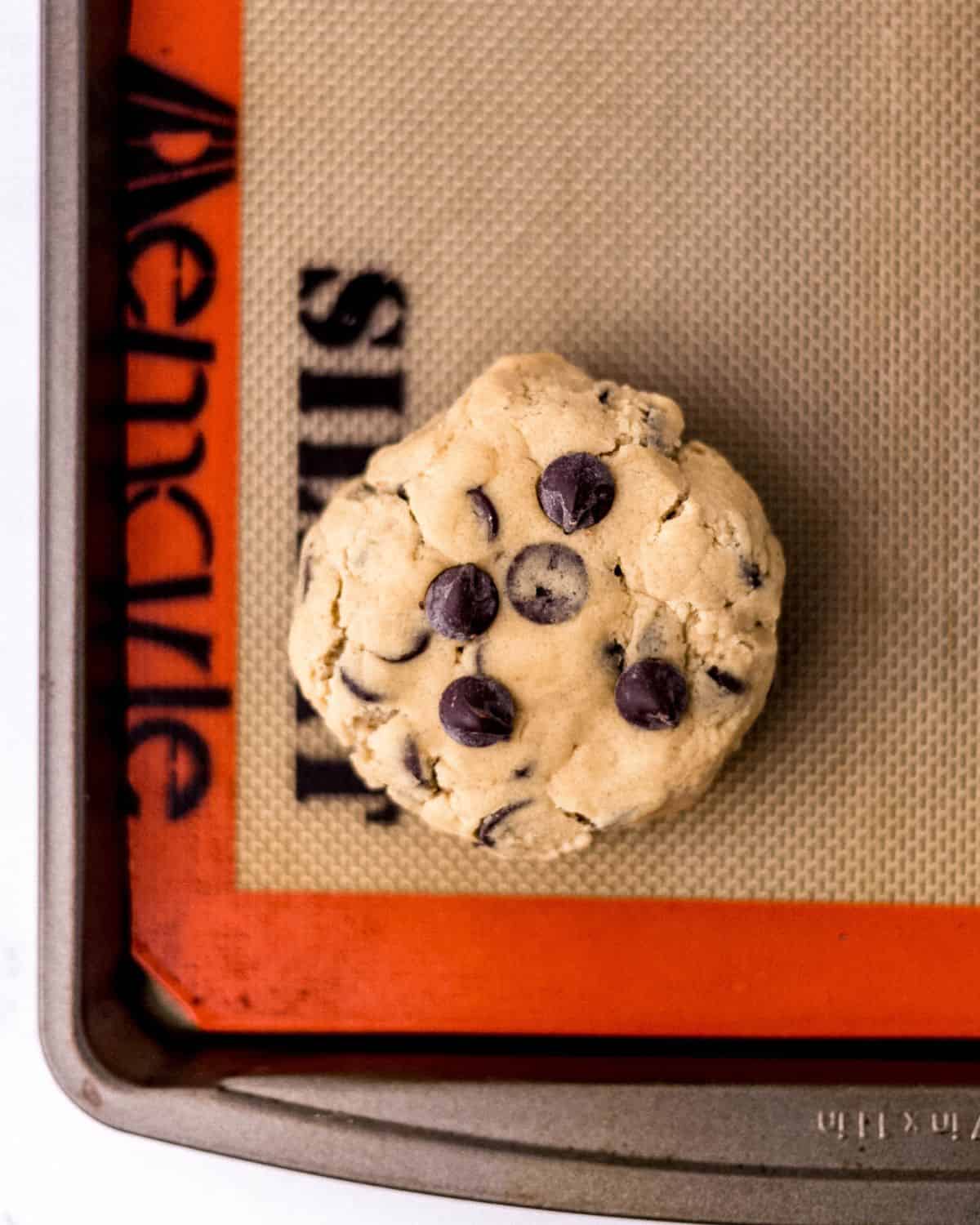 Overhead view of cookie dough on silpat lined baking sheet.