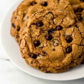 Close up view of cookies on white plate.