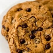 Close up view of cookies on white plate on pin with text overlay.