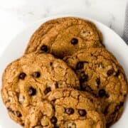 Overhead view of four cookies on large white plate on pin with text overlay.