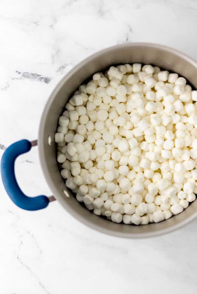 overhead view of marshmallows added to large pot 