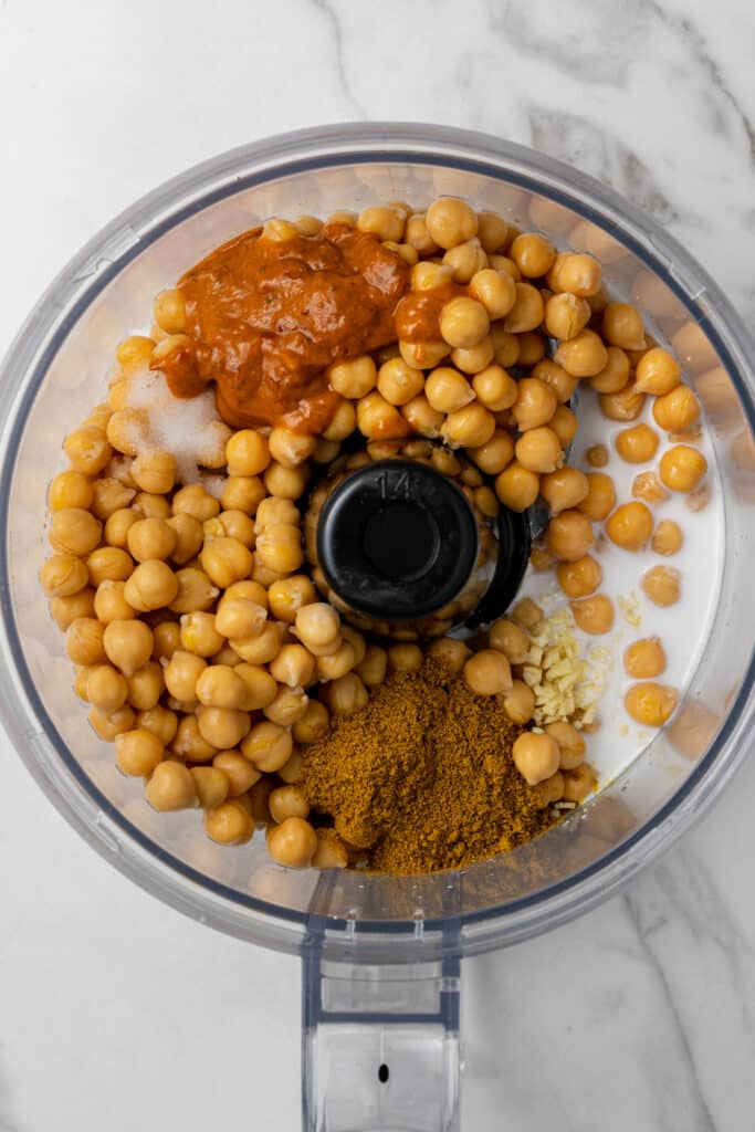 all ingredients to make hummus added into food processor 