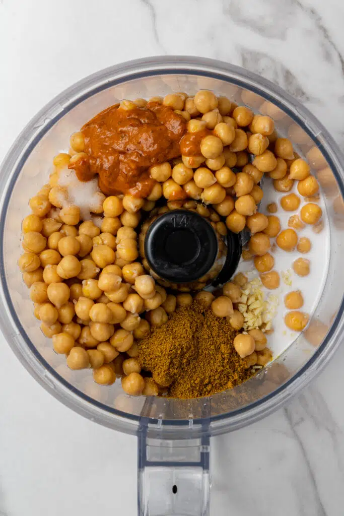 all ingredients to make hummus added into food processor 