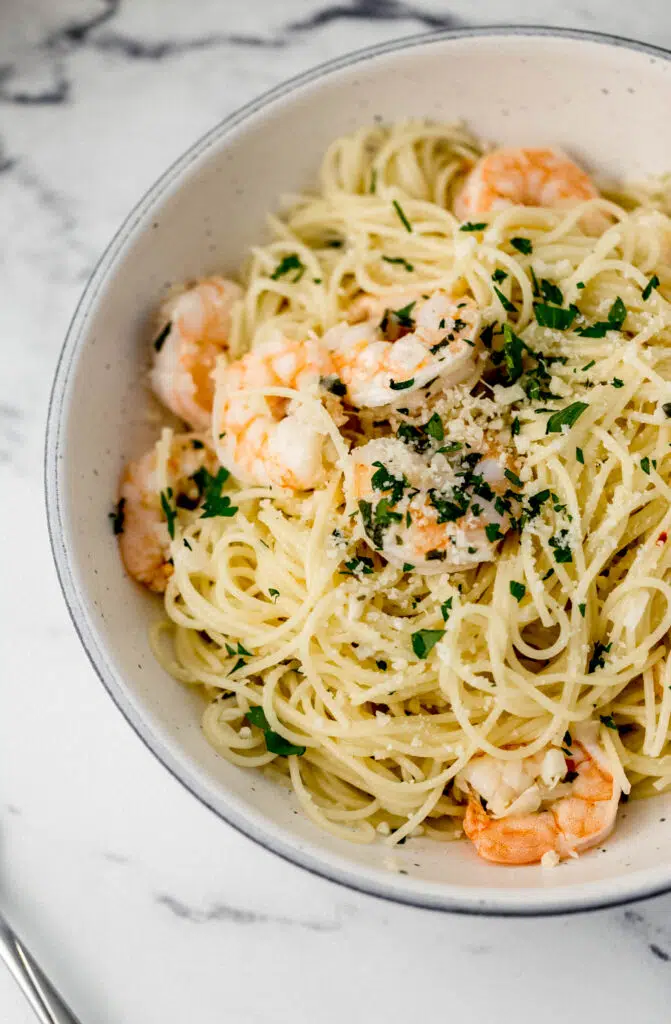 finished shrimp scampi in bowl next to fork