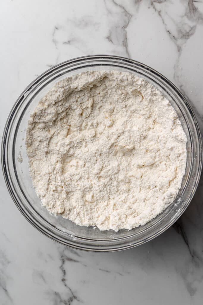 large glass bowl with flour mixture and butter
