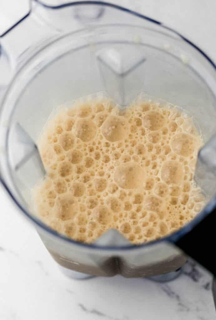 ingredients for frappe blended together in blender pitcher 