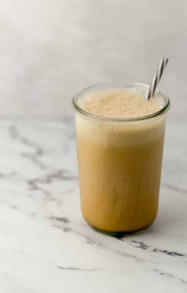 close up side view frappe in glass with straw 