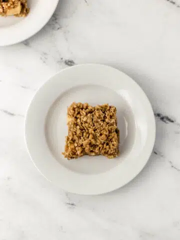 overhead view on apple crumble bar on white plate