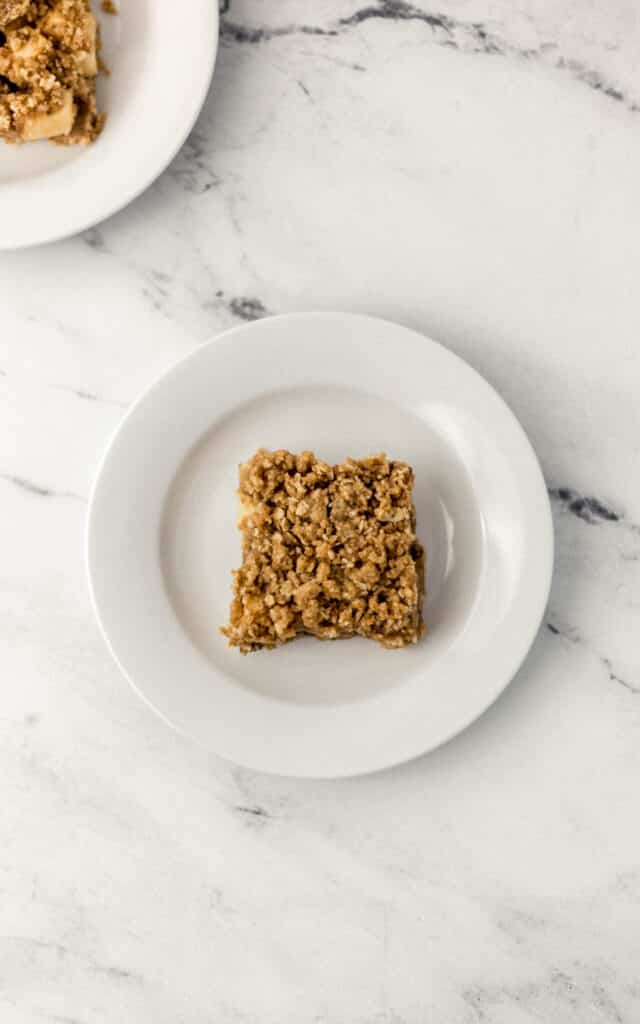 overhead view apple crumble bar on white plate 