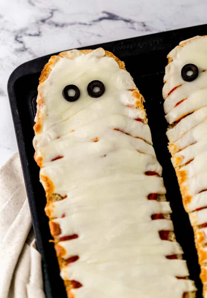 finished mummy pizza on sheet pan