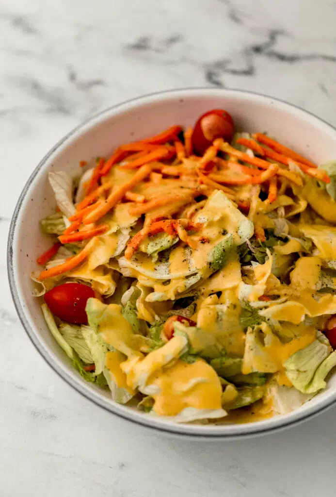 bowl of salad topped with dressing