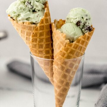 close up side view of two ice cream cones in glass