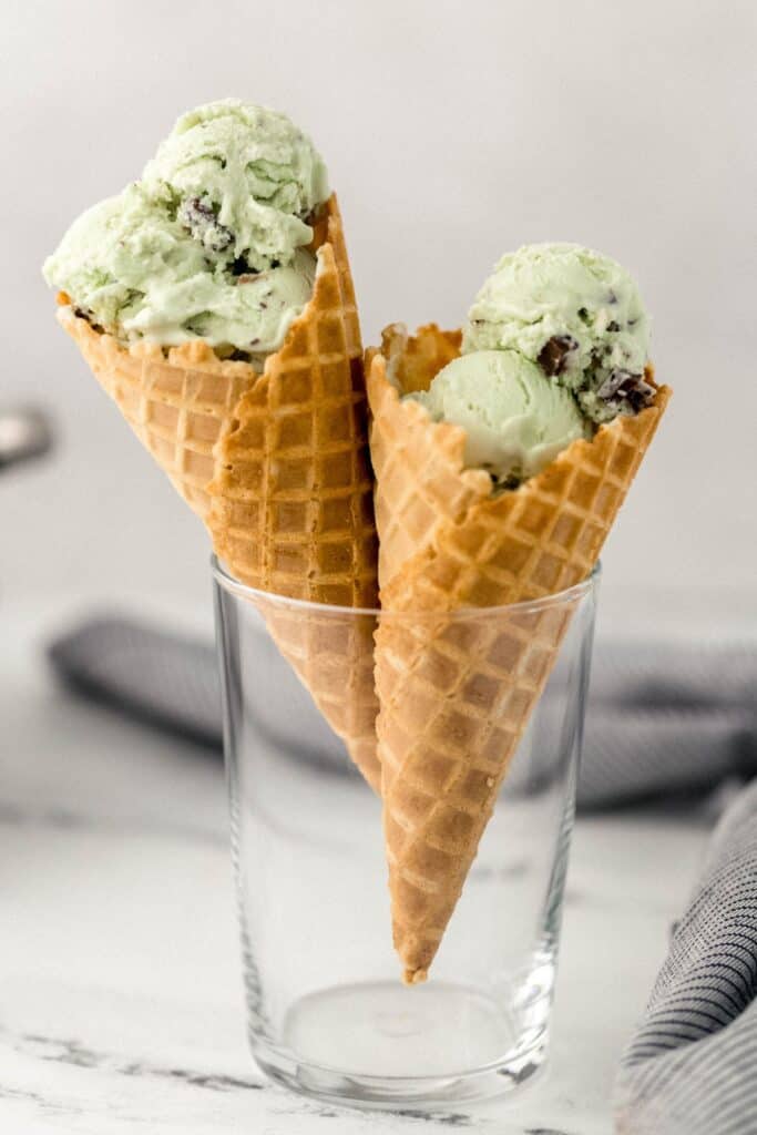 close up side view of two ice cream cones in glass