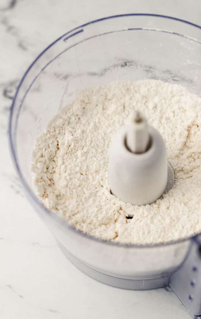 flour, baking powder, butter, and salt in food processor 