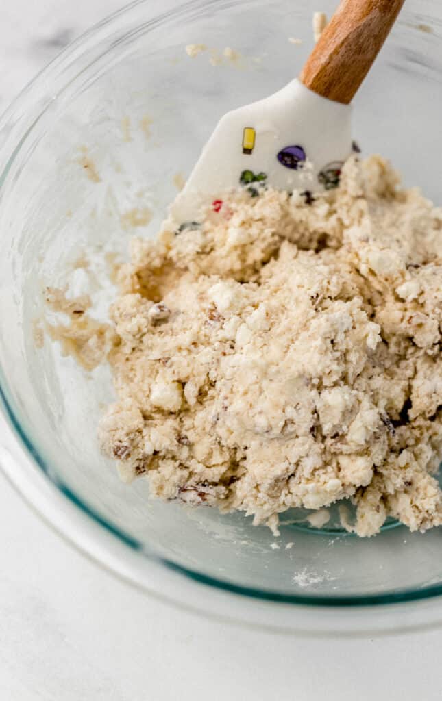 loose dough in glass mixing bowl with spatula 