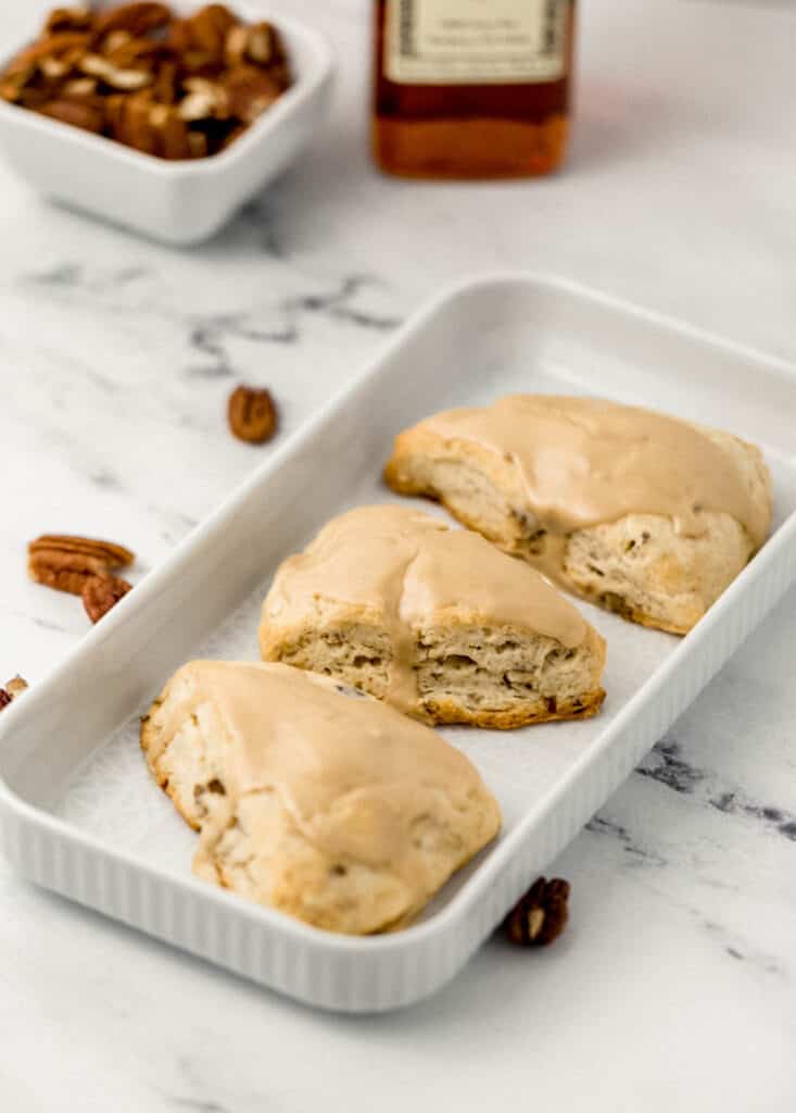 close up side view of finished scones on white rectangle platter 