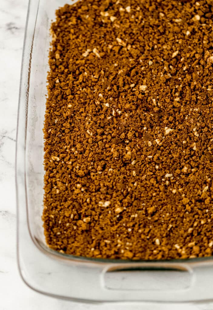Pumpkin Cheesecake Simply LaKita 8 cheesecake crust ingredients pressed into the bottom of a glass baking dish