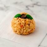 Close up view of single rice krispie treat on parchment paper.