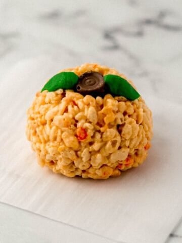 Close up view of single rice krispie treat on parchment paper.