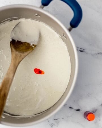 Orange food coloring added to melted marshmallow mixture.
