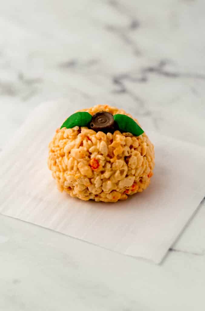 pumpkin rice krispie treat on parchment paper