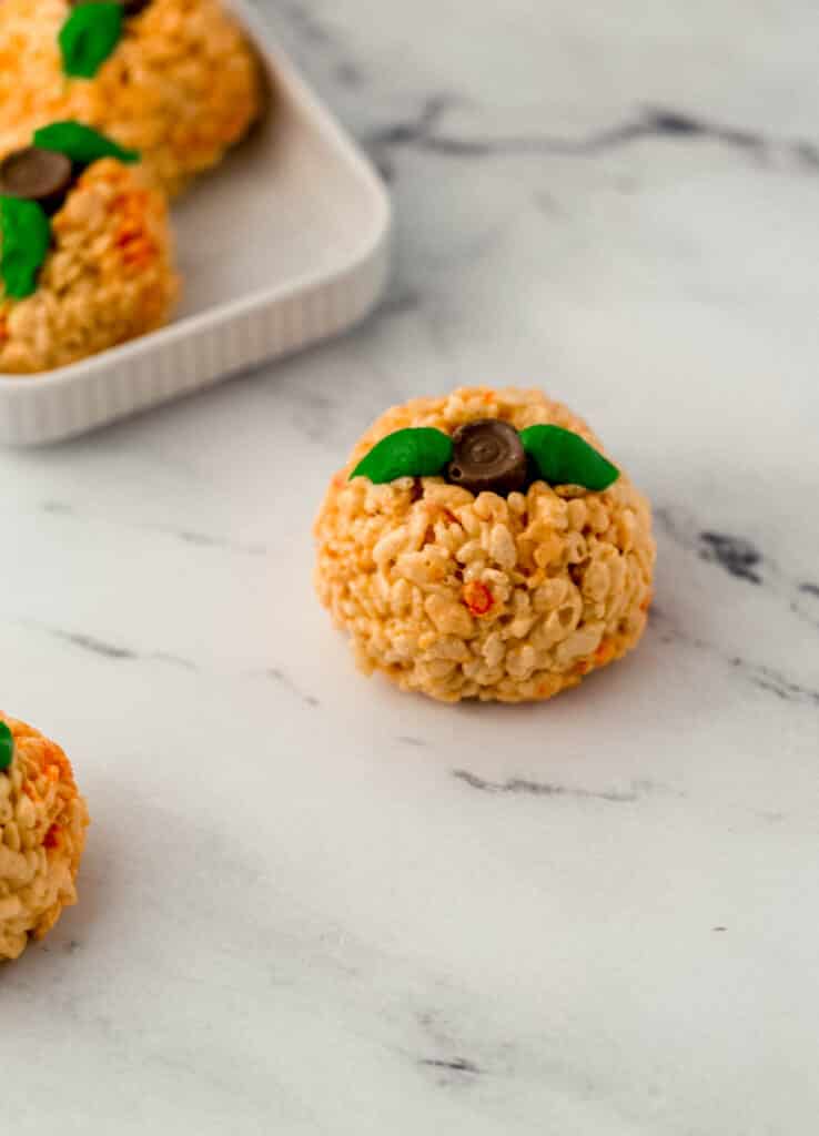 finished pumpkin sharped rice krispie treats on marble surface 