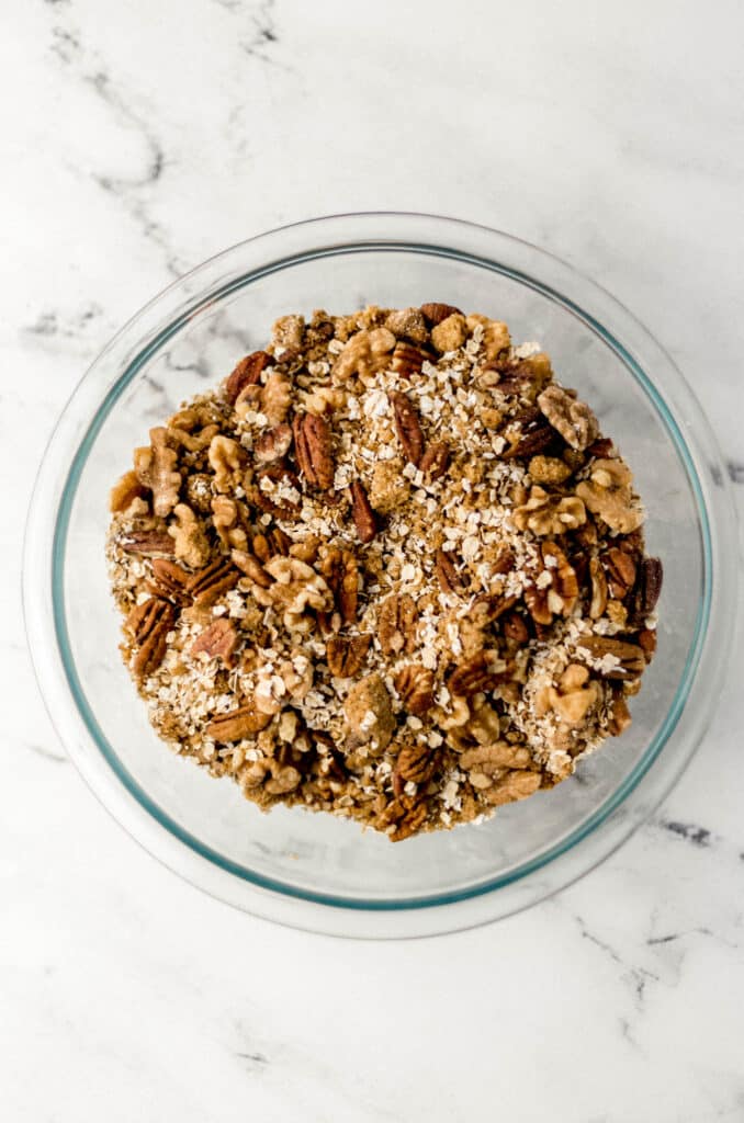 dry ingredients for granola mixed together in glass bowl 