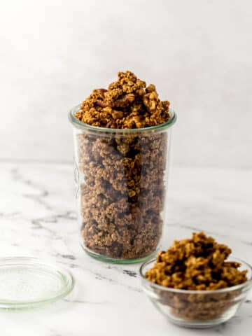 close up side view pumpkin spice granola in glass weck jar