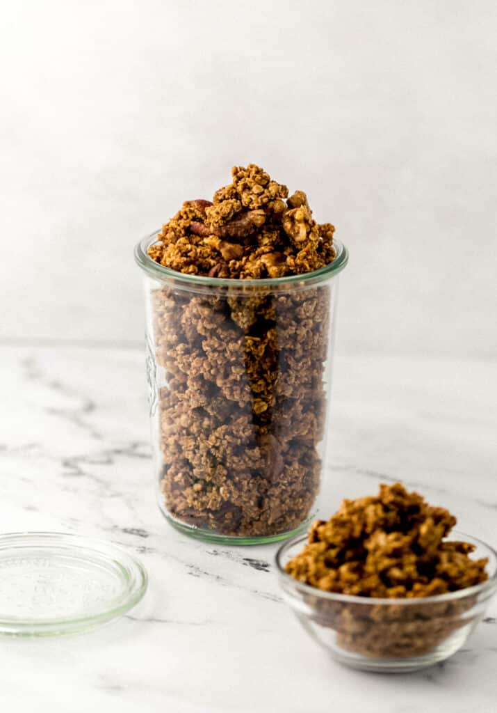 close up side view pumpkin spice granola in glass weck jar