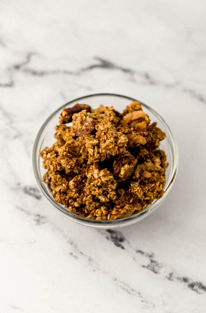 pumpkin spice granola in small glass bowl 