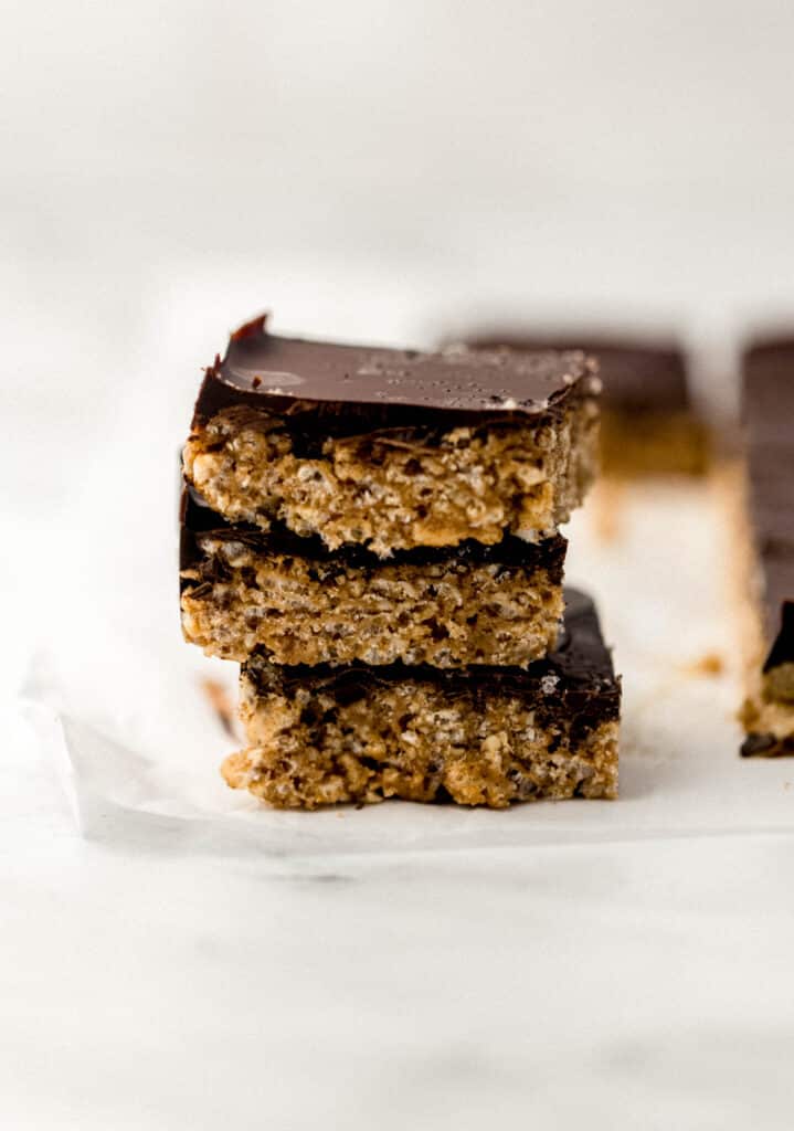 three chocolate almond butter crispy rice treats stacked on top of each other