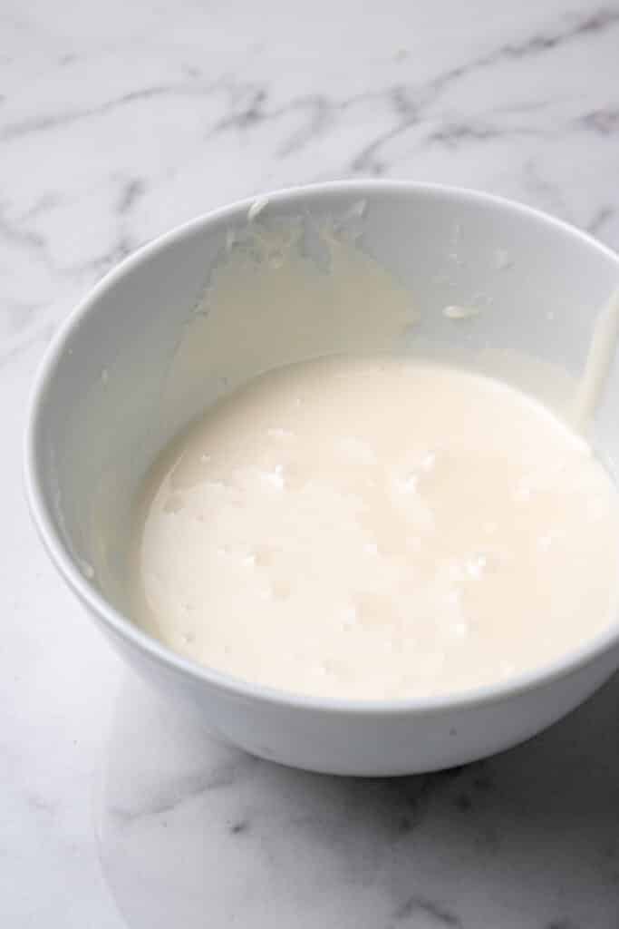 cake ingredients combined in white mixing bowl