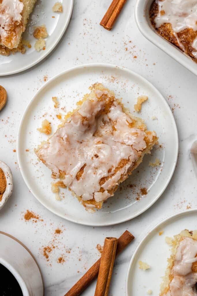 overhead view on square piece of cinnamon roll cake on white plate 