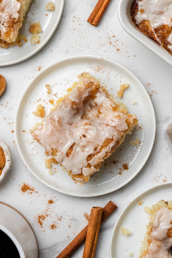 overhead view on square piece of cinnamon roll cake on white plate